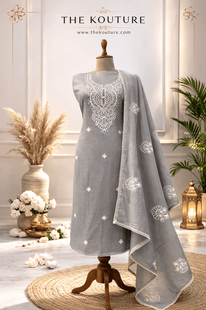 Grey embroidered cotton suit set with Dupatta for Women displayed elegantly in a stylish setting.