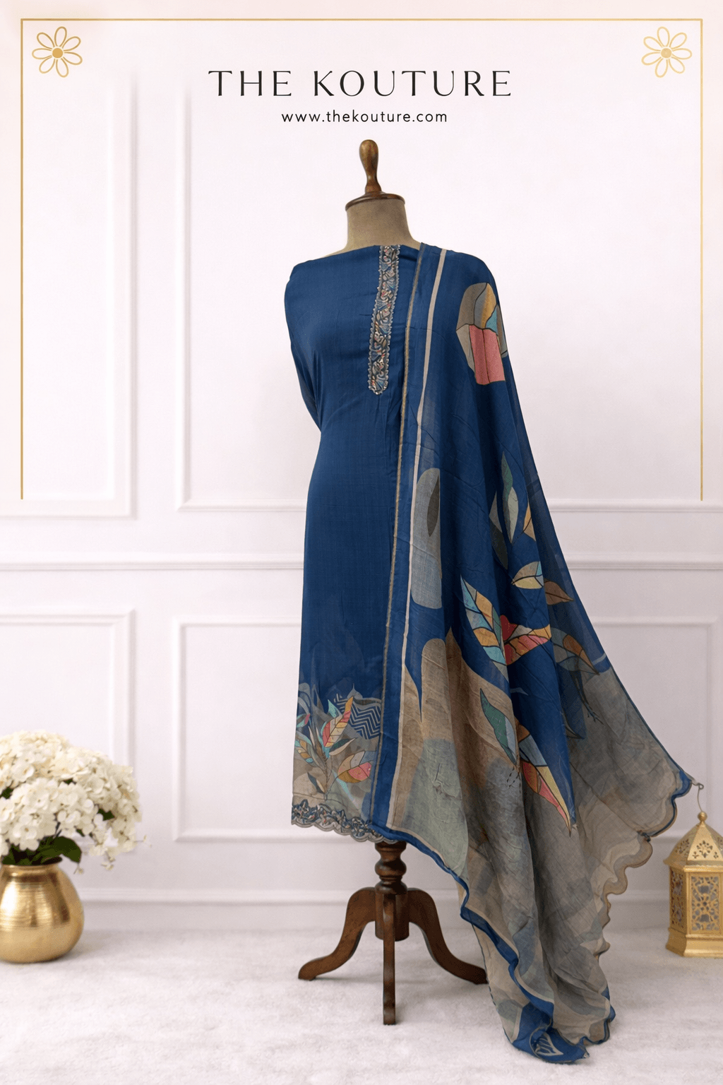 Navy blue muslin suit set with printed dupatta showcased on mannequin, elegant design for women.